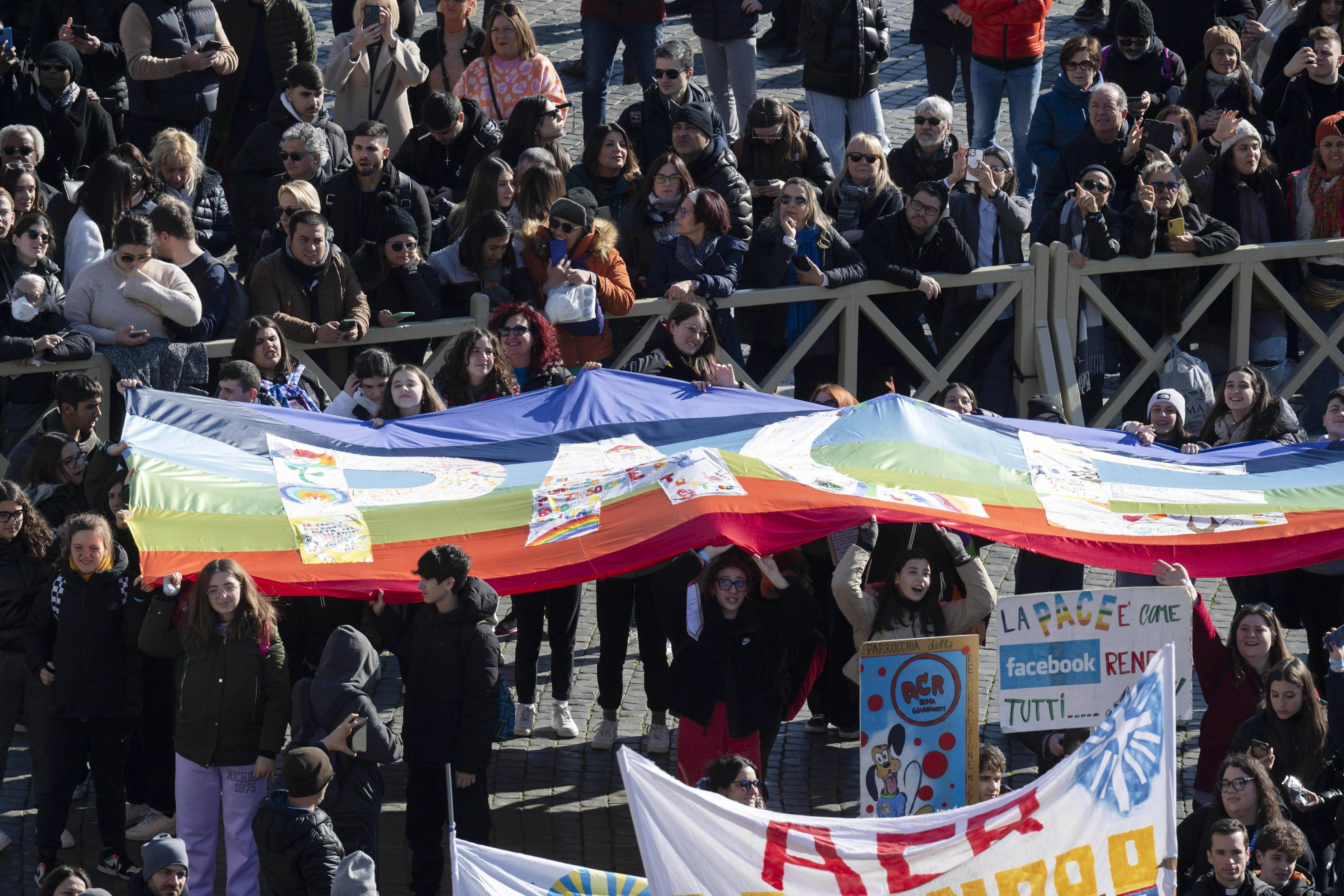 People in the crowd held up a "peace flag" as the pope prayed for peace in Ukraine and the Holy Land. Vatican Media