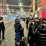 Israeli Maccabi Tel Aviv supporters are guarded by police after violence targeting Israeli soccer fans broke out in Amsterdam Nov. 8.