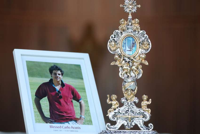 The reliquary containing remains of Blessed Carlo Acutis, and his photo. The Italian teen had a great love of the Eucharist and used his technology skills to build an online database of eucharistic miracles around the world.