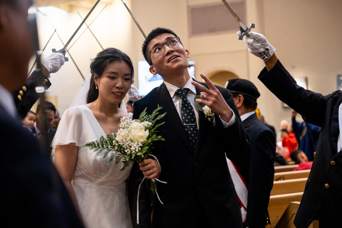 A groom flashes a peace sign at wedding-goers while processing out of St. Mary’s Church in Vancouver after having his marriage sacramentally blessed at the Marriage Mass on October 19. (Nicholas Elbers Photos)