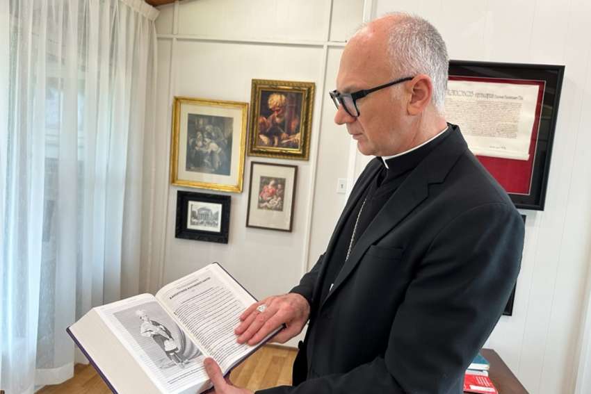 Bishop Joseph reflecting with the Holy Bible given to him by Mr. Harvey Satewas Gabriel (Photo courtesy Diocese of Charlottetown)