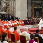 Pope Francis listens as Cardinal Angelo Acerbi, a 99-year-old retired Vatican diplomat, thanks him on behalf of the 21 new cardinals created at a consistory Dec. 7, 2024, in St. Peter's Basilica at the Vatican.