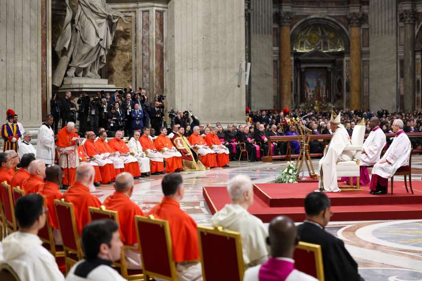 Pope Francis listens as Cardinal Angelo Acerbi, a 99-year-old retired Vatican diplomat, thanks him on behalf of the 21 new cardinals created at a consistory Dec. 7, 2024, in St. Peter's Basilica at the Vatican.