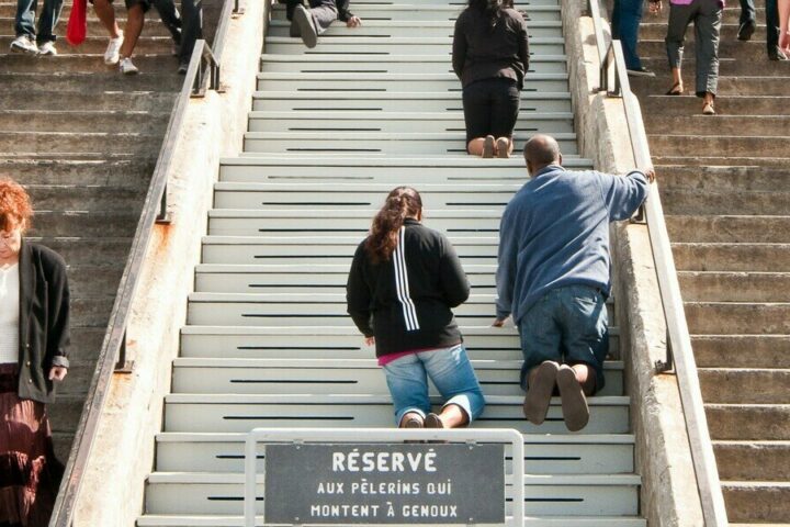 Pilgrims climb the stairs on their knees at Montreal’s St. Joseph’s Oratory. A federal politician asked if the practice would be banned under Quebec Premier François Legault’s proposal to prevent public prayer. (Michael Swan/The Catholic Register)