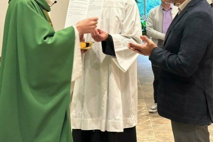 Knights of Columbus insurance salesman Mark Pan receives Communion from Father Maciej Wos at the Business Consecration Mass at St. Clare of Assisi Church in Coquitlam. (Submitted Photos)