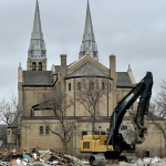 Construction underway at Holy Rosary Cathedral in Regina, Saskatchewan. New spires will be constructed in the cathedral’s parking lot, complete with structural steel, scaffolding, and metalwork, before being lifted back into place later next fall.